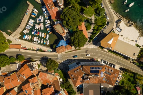 Preview: Aerial shot of a long road and beautiful houses with red rooftops