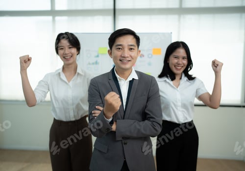 Preview: Group of positive asian business partners wearing suit standing crossed arms looking at camera with