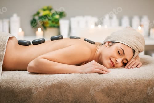 Preview: Woman Relaxing with Hot Stone Therapy at Spa