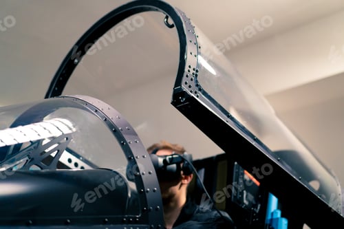 Preview: boy sitting in flight simulator military plane wearing virtual reality glasses flight entertainment