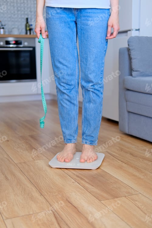 Preview: Barefoot Adult Measuring Weight Loss at Home