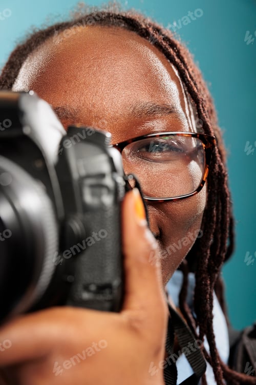 Preview: Close up of young adult woman with photography hobby and DSLR device taking photos.