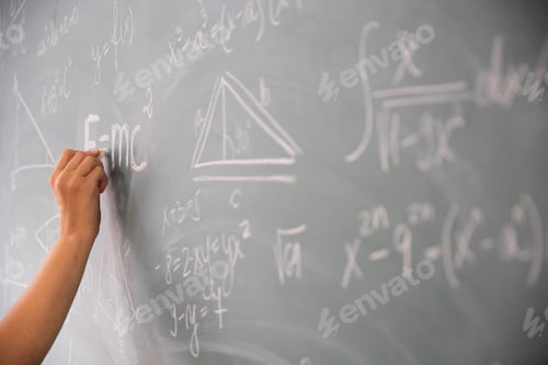 Preview: Teacher or student writing on blackboard during math lesson in school classroom