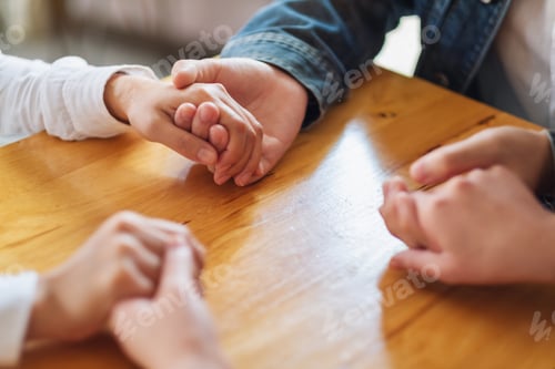 Preview: Group of people sitting in a circle holding hands and pray together or in therapy session