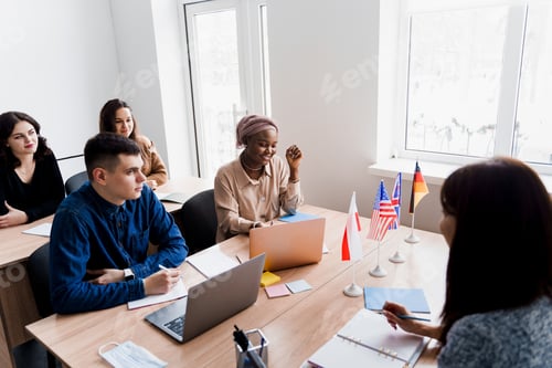 Preview: School language session with laptop, teacher explains grammar, multiple country flags