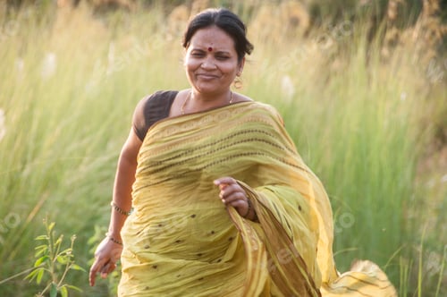 Preview: Happy Indian woman running in the meadow, Woman enjoying nature.