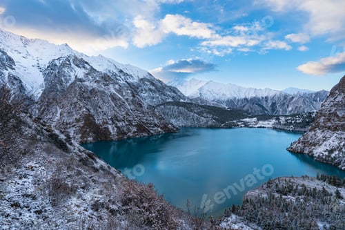 Preview: Tranquil landscape of an alpine lake, surrounded by majestic snow-covered mountains