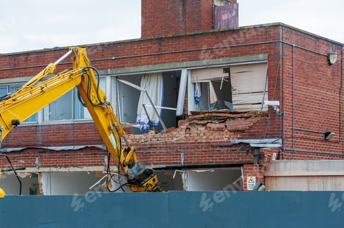 Preview: Demolition of an old building with a long reach machine hydraulic jaw.