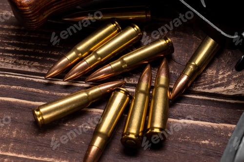 Preview: Bullets and Kalashnikov assault rifle on wooden background