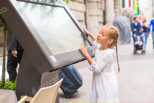Preview: Little adorable girl looking the map of Milan on italian vacation