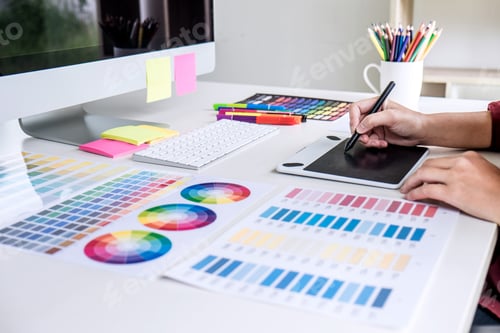 Preview: Image of female creative graphic designer working on color selection and drawing on graphics tablet