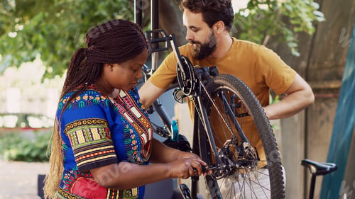 Preview: Multiethnic couple fixes damaged bicycle