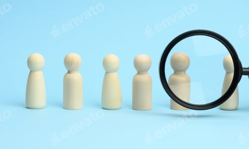 Preview: Wooden figures of men stand on a blue background and a black magnifying glass.