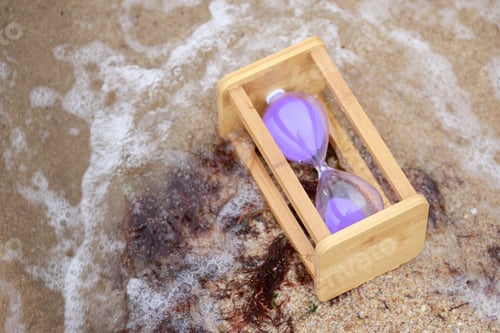 Preview: wooden hourglass at the beach