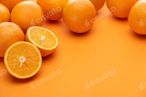 Preview: ripe delicious cut and whole oranges on colorful background
