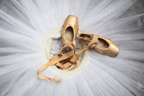 Preview: Ballet shoes with ribbons on a white tutu in a dance studio
