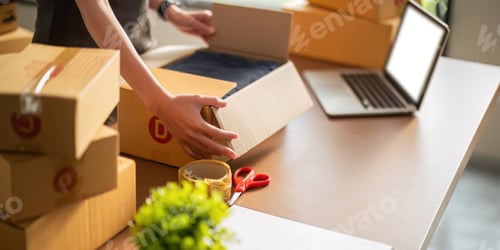 Preview: Close up young woman seller prepare parcel box of product for deliver to customer. Online selling