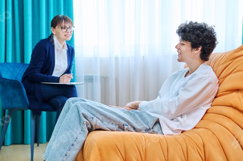 Preview: Young guy in therapy discussing his problems with female psychotherapist