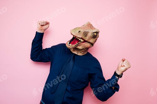 Preview: Euphoric man with dinosaur head with raised fists