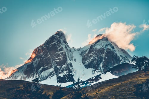 Preview: Sunset evening view over the snowy mountain peak