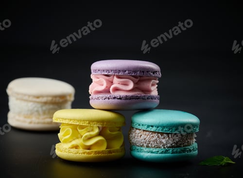 Preview: A stack of multi-colored macaroons on a wooden board. Delicious dessert