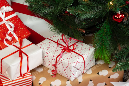 Preview: Pile of wrapped presents under the Christmas tree
