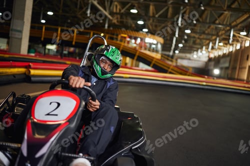 Preview: go cart speed drive, african american driver in helmet on circuit, karting motorsport concept