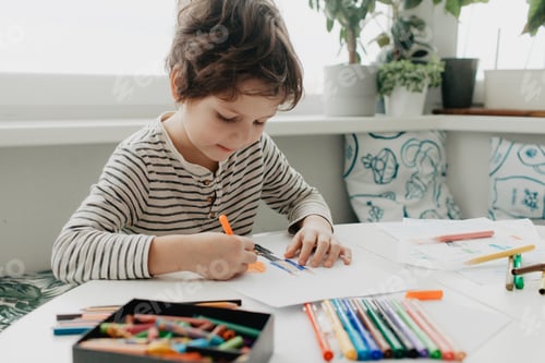 Preview: The boy draws with felt-tip pens