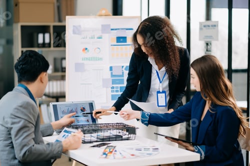 Preview: Creative business people working on business project in office