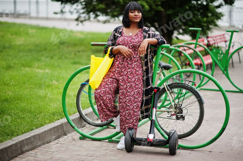 Preview: African american woman using segway or hoverboard