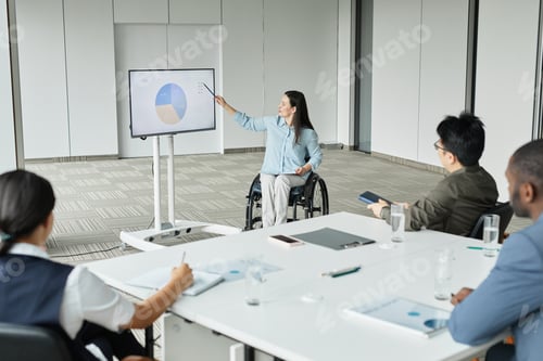 Preview: Woman in Wheelchair Leading Business Meeting