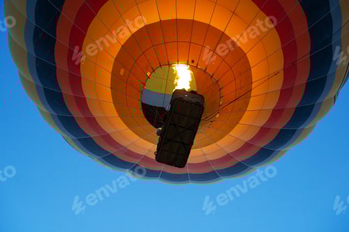 Preview: colorful hot air balloon rising up using burner flame
