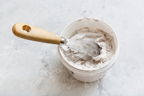 Preview: metal spatula in pot with putty