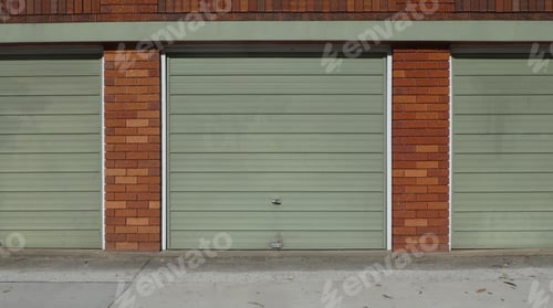 Preview: Green garage doors on brick frame,street view