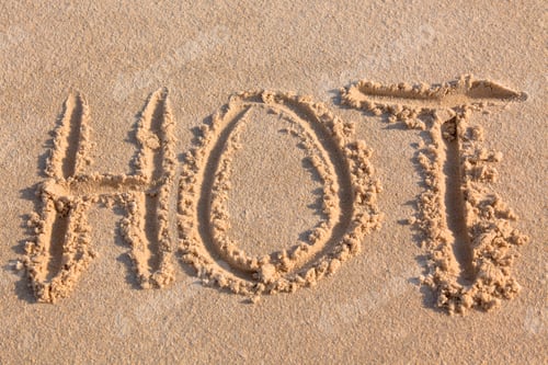 Preview: word "hot" written on beach sand