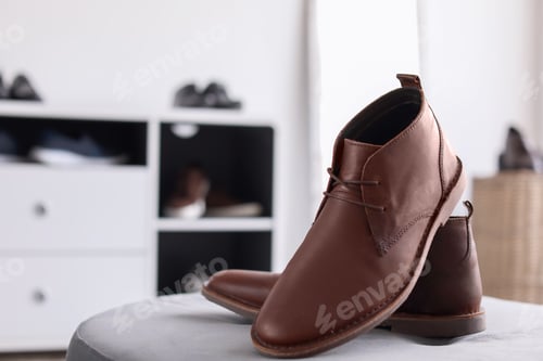 Preview: Male shoes on pouf in store