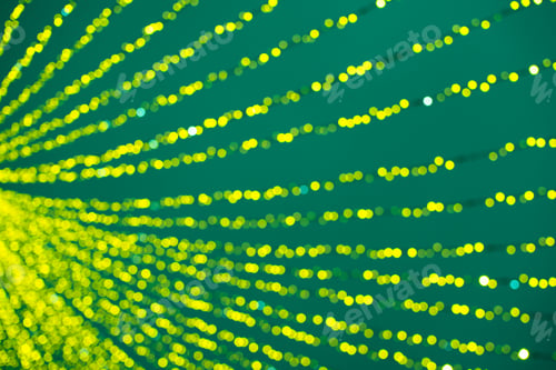 Preview: Green and yellow abstract background of bokeh defocused blurred lights garland