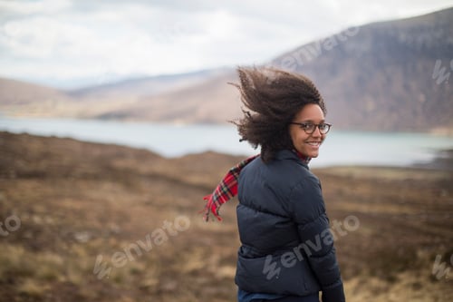 Preview: Mid adult woman in mountains looking at camera