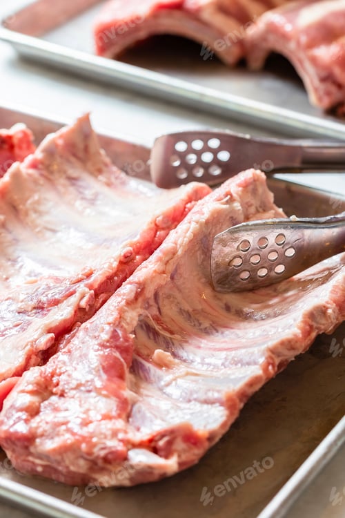 Preview: Raw meat on the metal tray. Cooking pork ribs for barbecue grill