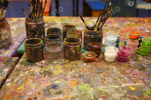 Preview: Paints and paint brushes in an artists studio.