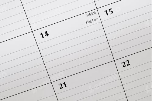 Preview: Overhead view of June 14 or Flag day on a desk calendar