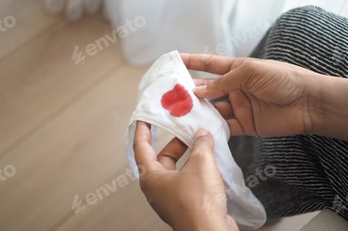 Preview: Woman Hands holding white underwear with blood stain