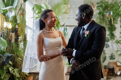 Preview: Black young couple getting married in tropical orangerie