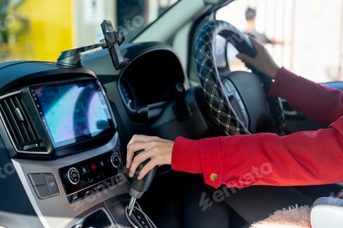 Preview: Close up hands of woman hold joystick or steering wheel and gear lever of car in concept safe drive