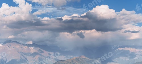 Preview: Fantastic snow-capped mountains in the beautiful cumulus clouds. Main Caucasian Ridge