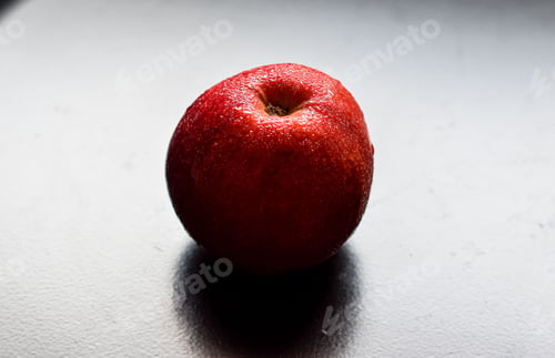 Preview: Closeup of a wet red apple on the table.
