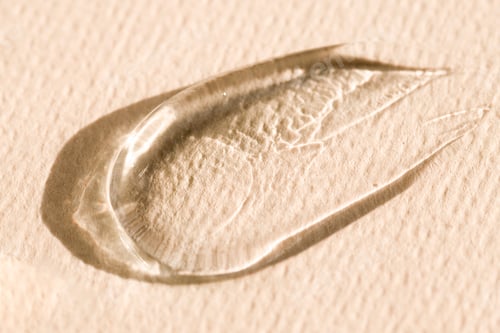 Preview: Texture of a transparent cosmetic product, gel, serum on a beige background. Care product sample.