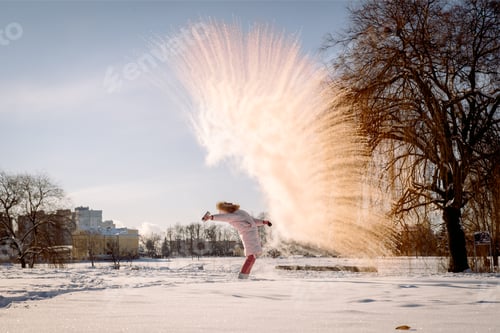 Preview: Cold frosty day. frost and snowflakes. The girl throws boiling water in the cold, ice and icicles