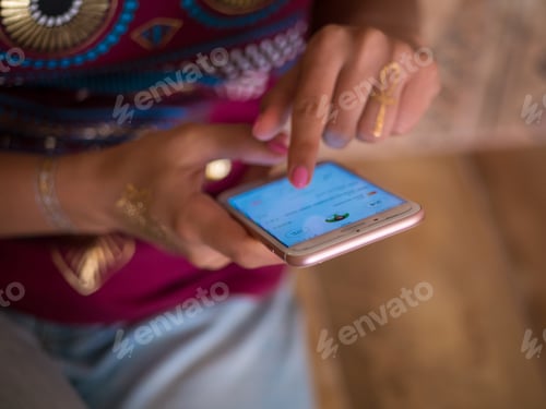 Preview: Young girl with flash tattoo on hands using smartphone