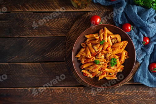 Preview: Pasta penne in marinara sauce with mussels, onion and parsley. Classic Italian pasta penne. Top view
